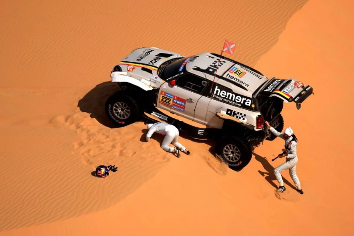 Belgian driver Guillaume de Mevius and French co-driver Mathieu Baumel check their car during Stage 10 of the Dakar Rally 2025, between Haradh and Shubaytah, Saudi Arabia, on January 15, 2025.  Valery HACHE / AFP