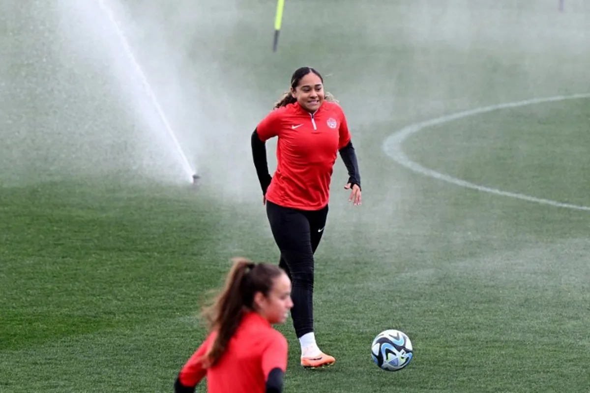 Canada's Olivia Smith reacts as the sprinklers are turned on in a training session at the Lakeside Stadium in Melbourne on July 30, 2023, on the eve of the Women's World Cup football match between Canada and Australia. William WEST / AFP