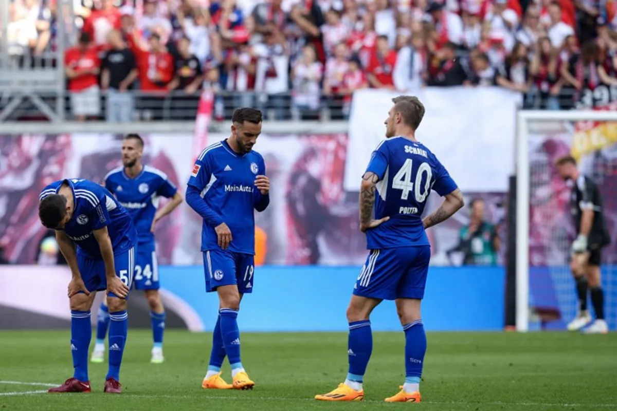 Schalke 04 players react at the  final whistle of the German first division Bundesliga football match between RB Leipzig and FC Schalke 04 in Leipzig, eastern Germany on May 27, 2023.  Ronny HARTMANN / AFP