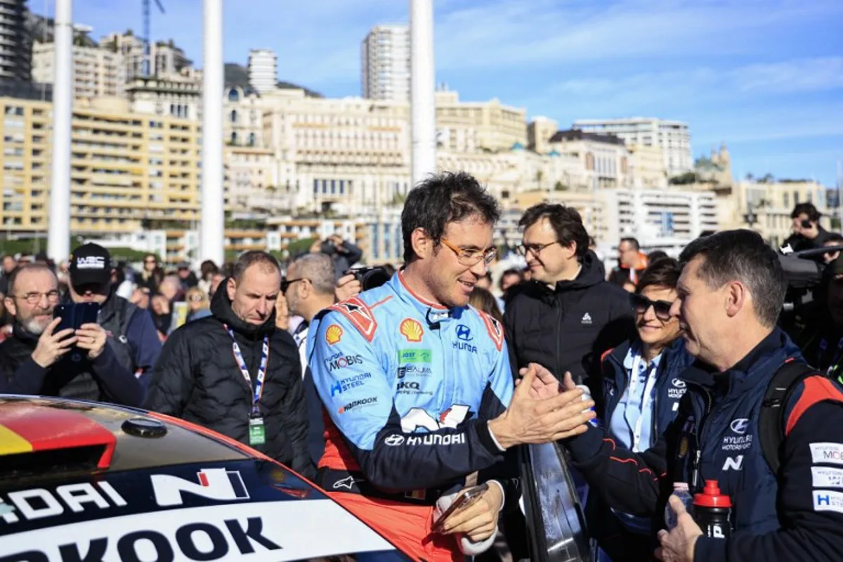 Hyundai Shell Mobis World Rally Team's Belgian driver Thierry Neuville (C) celebrates as he arrives at the Monaco's Casino Square at the end of the 93nd WRC Monte-Carlo Rally in Monaco, on January 26, 2025.  Valery HACHE / AFP