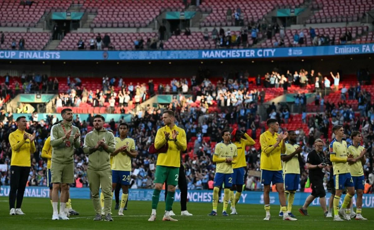 Southampton's players applaud fans on the pitch after the English FA Cup semi final football match between Manchester City and Southampton at Wembley stadium in London, on April 25, 2026. City won the game 2-1 Ben STANSALL / AFP