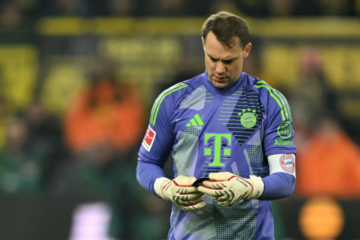 Bayern Munich's German goalkeeper #01 Manuel Neuer looks at the shin guard of Dortmund's Guinean forward #09 Serhou Guirassy during the German first division Bundesliga football match between Borussia Dortmund and FC Bayern Munich in Dortmund, western Germany on November 30, 2024.  INA FASSBENDER / AFP