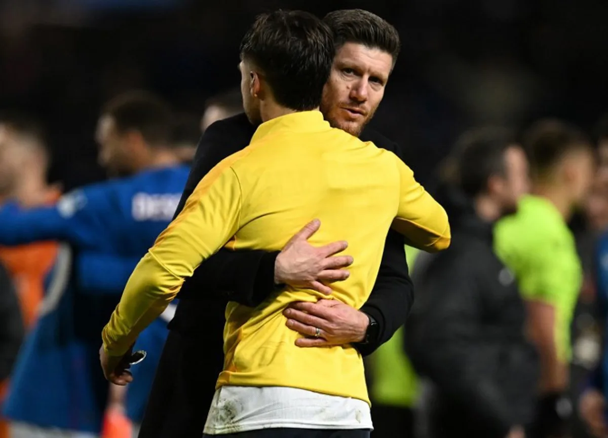 Union's Belgian head coach Sebastien Pocognoli consoles a player during the UEFA Europa League football match between Rangers and Royale Union Saint-Gilloise at the Ibrox Stadium in Glasgow on January 30, 2025. Rangers won the match 2-1. ANDY BUCHANAN / AFP