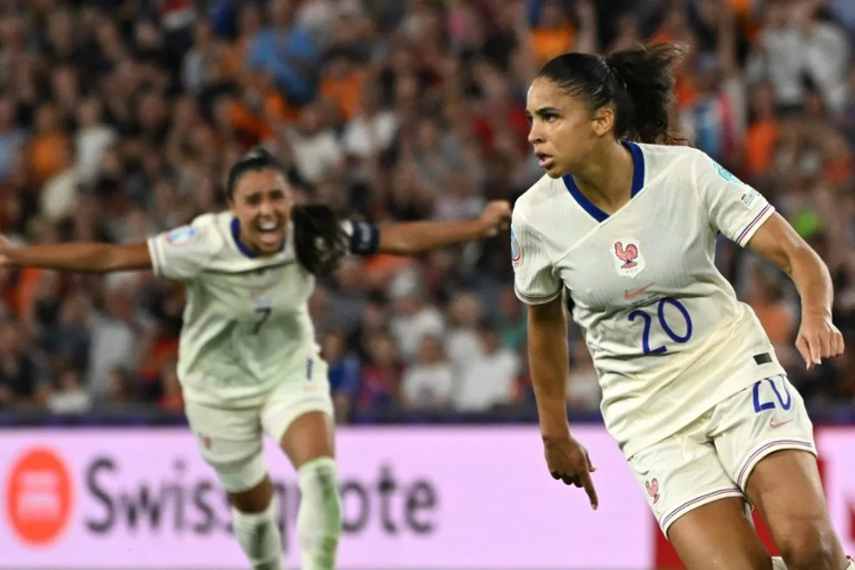 France's forward #20 Delphine Cascarino (R) celebrates after scoring France's third goal during the UEFA Women's Euro 2025 Group D football match between The Netherlands and France at the St. Jakob-Park Stadium in Basel, on July 13, 2025. Miguel MEDINA / AFP