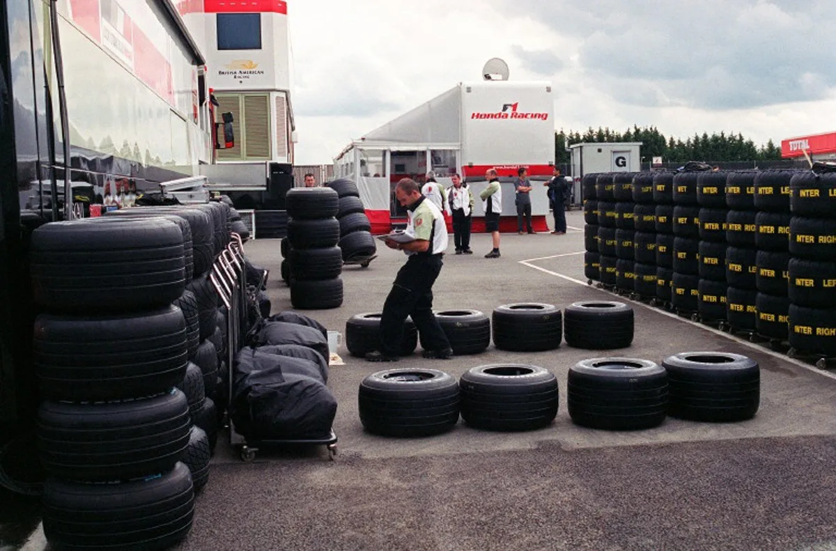 A BAR-Honda technician checks the Bridgestone tires available for the two racing cars during the British Formula One Grand Prix 05 July 2002 in the paddocks of the Silverstone racetrack. AFP PHOTO JEAN-PIERRE MULLER JEAN-PIERRE MULLER / AFP
