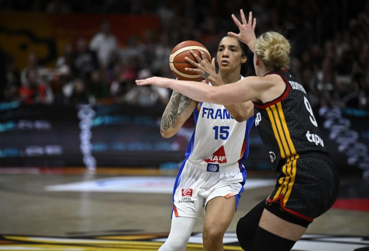France's forward #15 Gabby Williams (L) and Germany's small forward #09 Emma Eichmeyer vie for the ball during the 2026 FIBA Women's Basketball World Cup semi-final match between France and Germany in Berlin on September 12, 2026. Tobias SCHWARZ / AFP