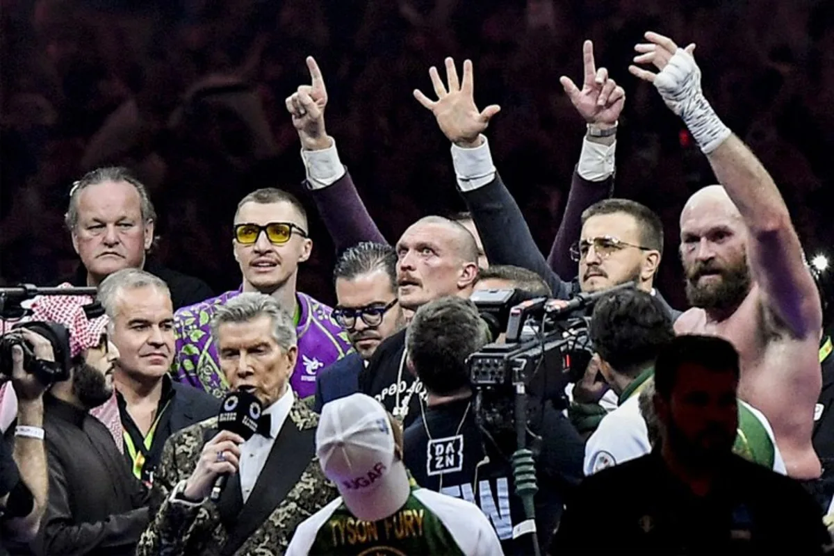 Ukraine's Oleksandr Usyk and Britain's Tyson Fury stand in the ring during the announcement of the winner after their heavyweight world championship rematch at the Kingdom Arena in Riyadh on December 22, 2024.  AFP