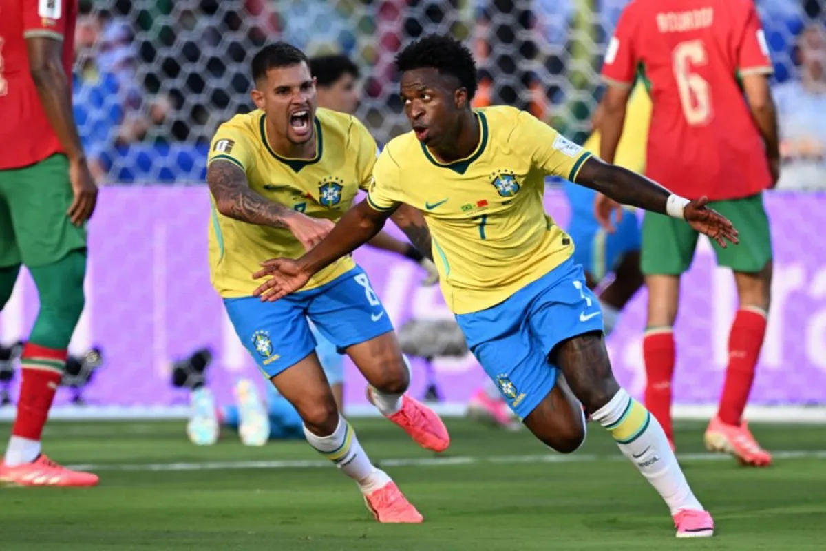 Brazil's forward #07 Vinicius Junior (R) celebrates scoring his team's first goal during the 2026 World Cup Group C football match between Brazil and Morocco at the New York/New Jersey Stadium in East Rutherford on June 13, 2026. Jewel SAMAD / AFP