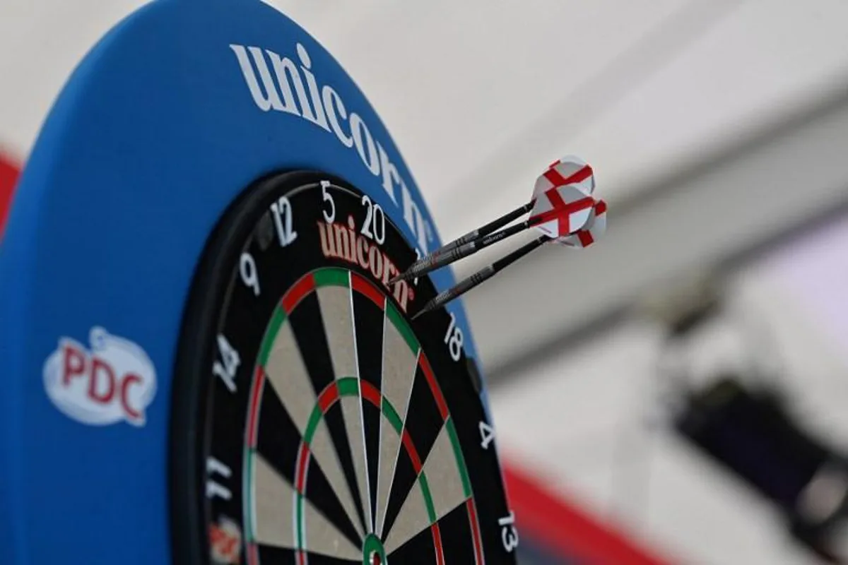 Three darts thrown by England's forward Dominic Calvert-Lewin miss the board during a press conference at St George's Park in Burton-on-Trent on June 26, 2021 during the UEFA EURO 2020 football competition.  Paul ELLIS / POOL / AFP