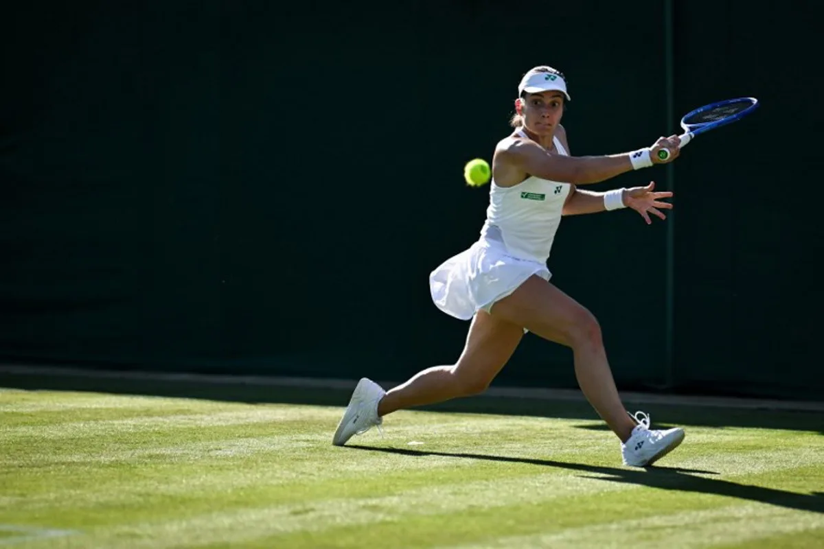 Latvia's Anastasija Sevastova plays a backhand return to Italy's Jasmine Paolini during their women's singles first round tennis match on the first day of the 2025 Wimbledon Championships at The All England Lawn Tennis and Croquet Club in Wimbledon, southwest London, on June 30, 2025. Kirill KUDRYAVTSEV / AFP