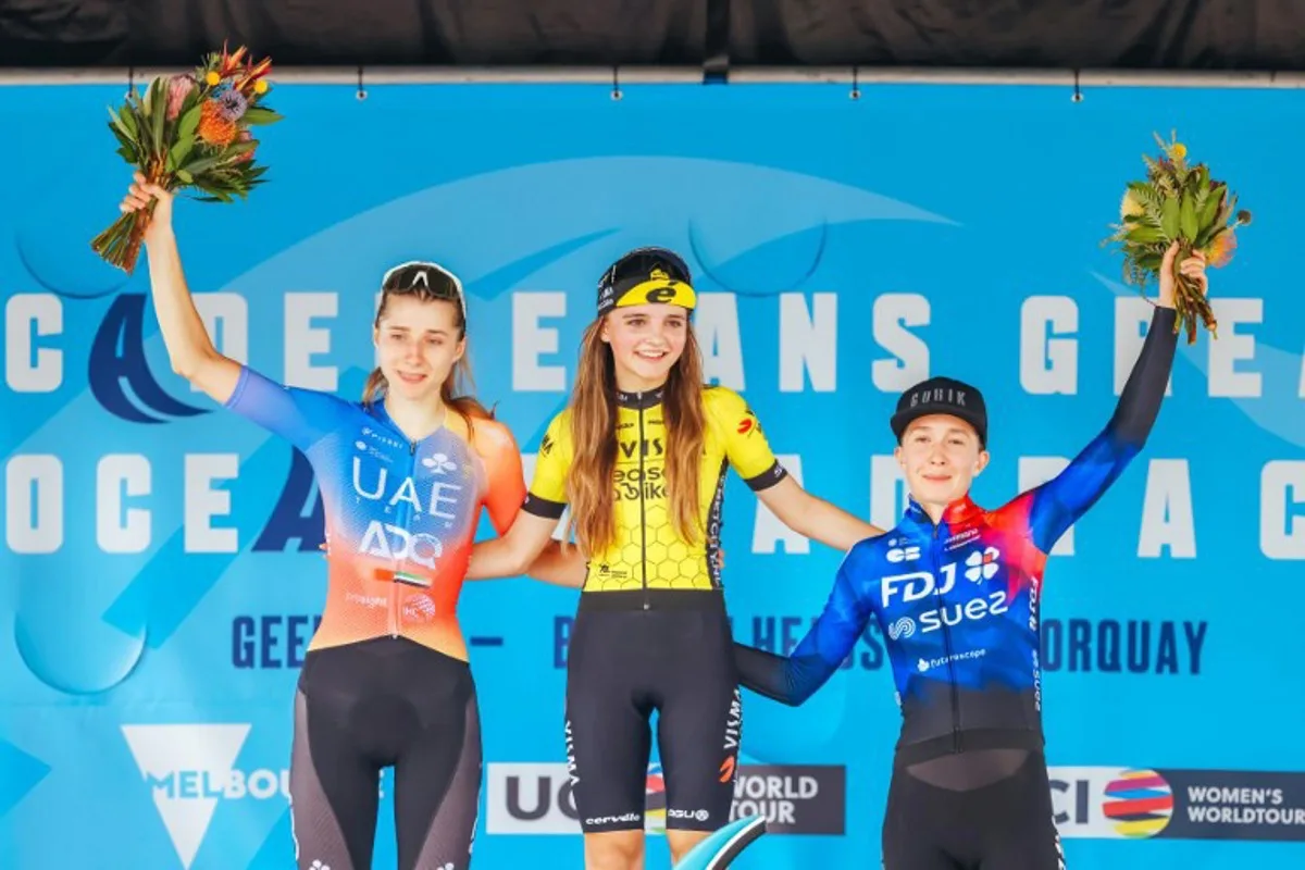 (L-R) Second-placed UAE Team Adq's Dominika Wlodarczyk of Poland, winner Team Visma Lease A Bike Women's Rosita Reijnhout of the Netherlands, and third-placed Team FDJ Suez's Cecilie Ludwig of Denmark celebrate on the podium during the award ceremony of the 2024 Women's Elite Cadel Evans Great Ocean Road Race cycling event in Geelong on January 27, 2024.  CHRIS PUTNAM / AFP