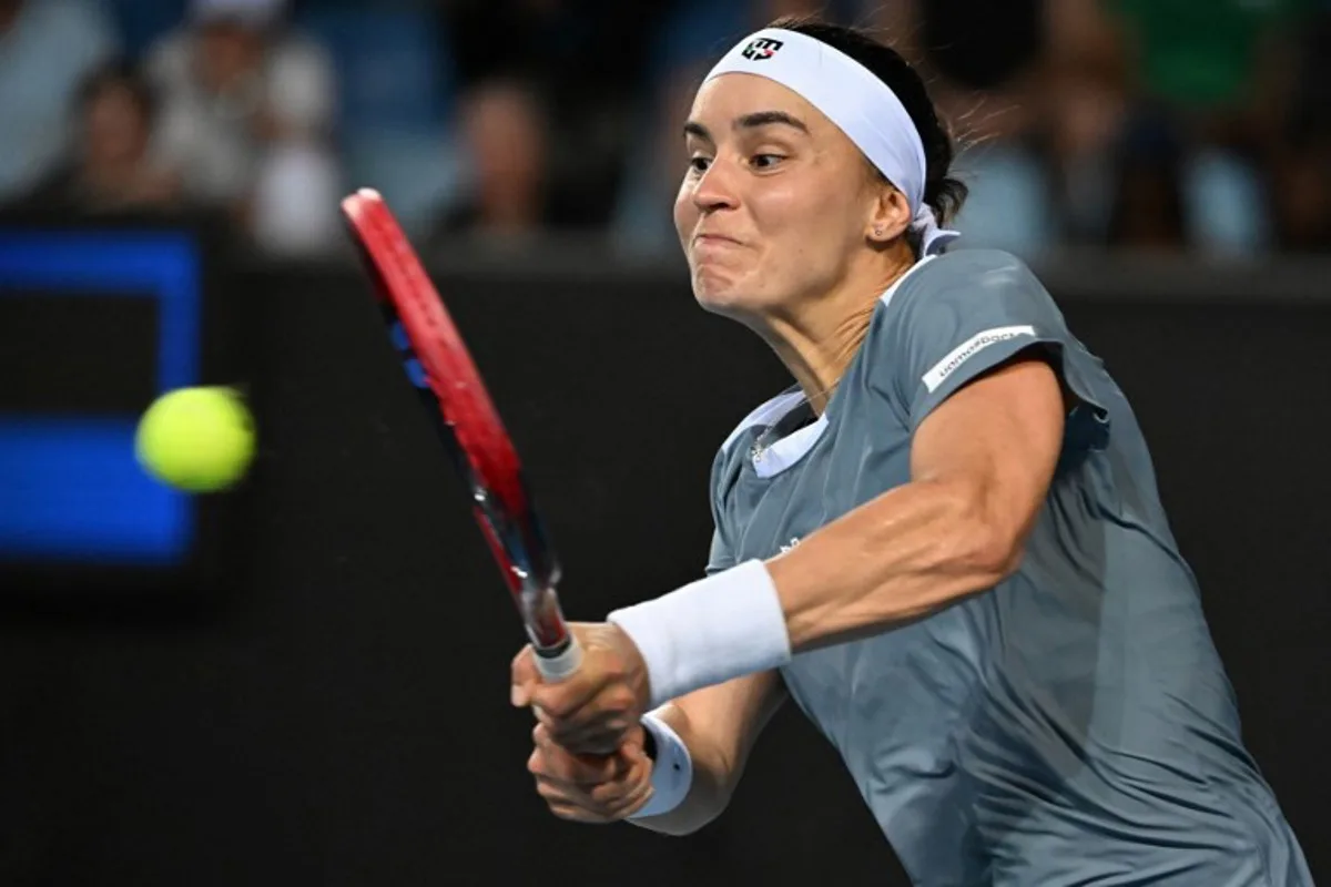Ukraine's Anhelina Kalinina hits a shot against Tunisia's Ons Jabeur during their women's singles match on day three of the Australian Open tennis tournament in Melbourne on January 14, 2025. Paul Crock / AFP
