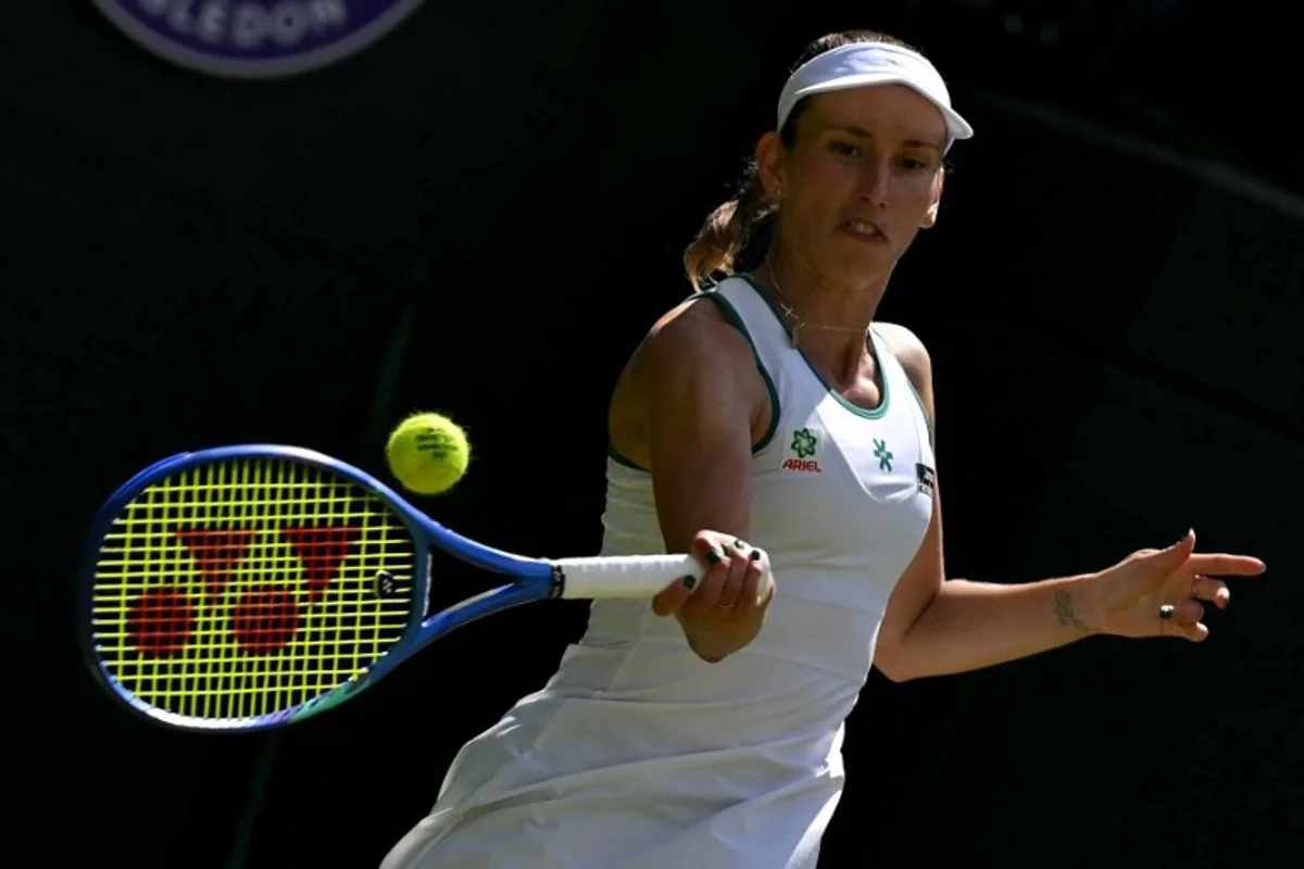 Belgium's Elise Mertens returns to Kazakhstan's Elena Rybakina during their women's singles third round tennis match on the sixth day of the 2026 Wimbledon Championships at The All England Lawn Tennis and Croquet Club in Wimbledon, southwest London, on July 4, 2026. Glyn KIRK / AFP