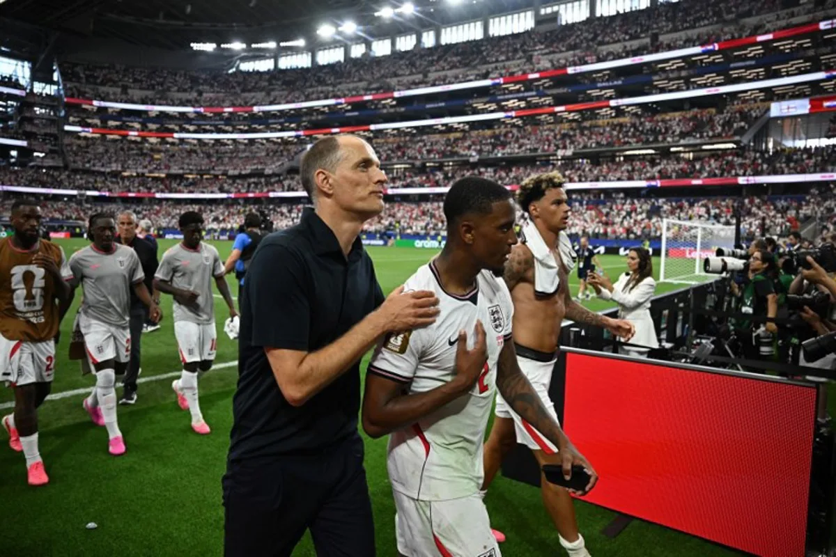 England's German head coach Thomas Tuchel (L) reacts with England's defender #02 Ezri Konsa after winning the 2026 World Cup Group L football match between England and Croatia at the Dallas Stadium in Arlington on June 17, 2026. Paul ELLIS / AFP