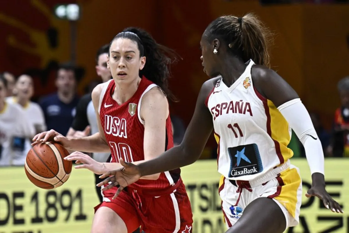 USA's power forward #10 Breanna Stewart and Spain's center #11 Awa Fam vie for the ball during the 2026 FIBA Women's Basketball World Cup semi-final match between Spain and the United States in Berlin on September 12, 2026.  Tobias SCHWARZ / AFP