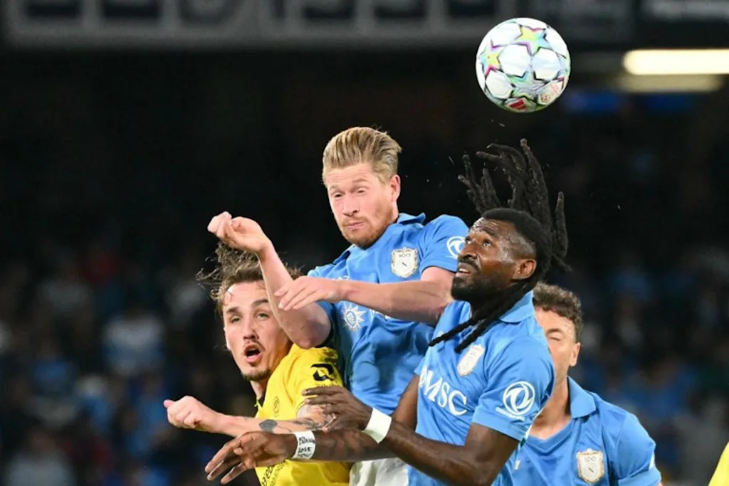 Napoli's Cameroonian midfielder #99 Andre-Frank Anguissa and Napoli's Belgian midfielder #11 Kevin De Bruyne jump for the ball during the UEFA Champions League - first round day 3 football match between Napoli and Bodo Glimt at the Diego Armando Maradona stadium in Naples on October 20, 2026.  Alberto PIZZOLI / AFP