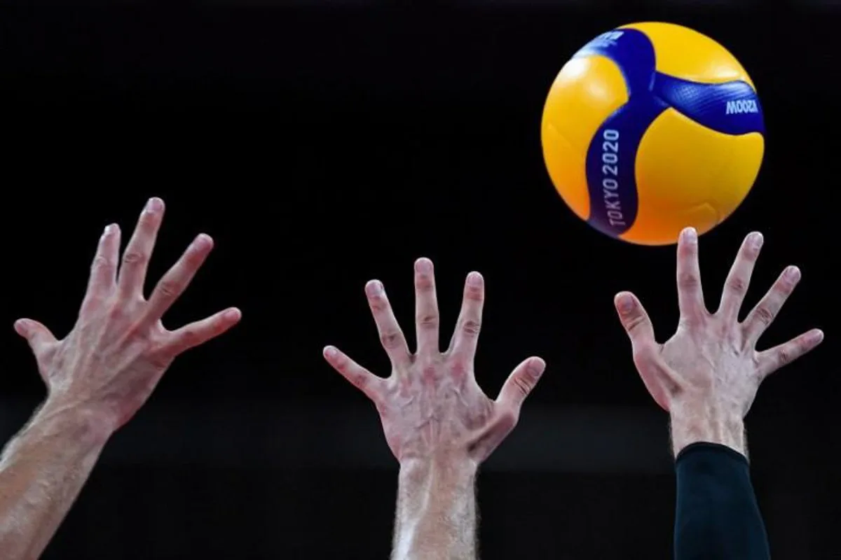 Canada's players attempt to block a shot in the men's preliminary round pool A volleyball match between Japan and Canada during the Tokyo 2020 Olympic Games at Ariake Arena in Tokyo on July 26, 2021.  Yuri Cortez / AFP