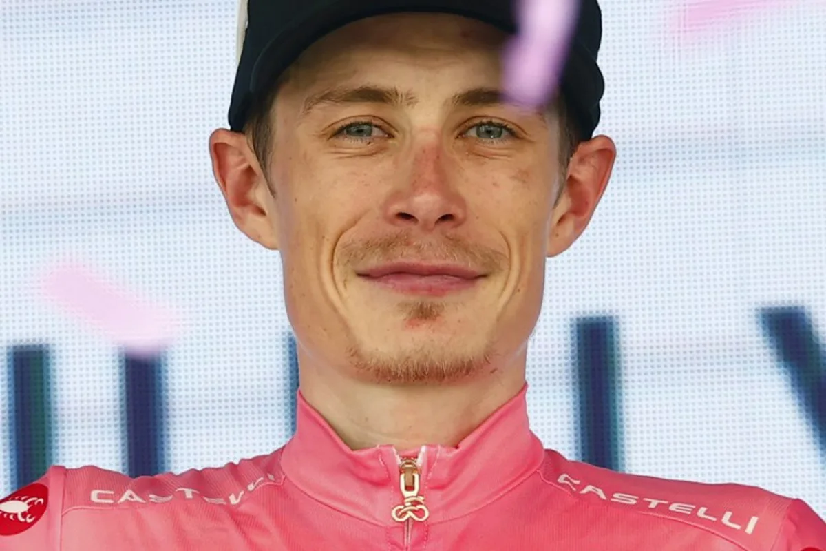 Team Visma Lease a Bike Danish rider Jonas Vingegaard celebrates the overall leader's pink jersey on the podium of the 15th stage of the Giro d'Italia 2026 - Tour of Italy cycling race between Voghera and Milan, Italy, on May 24, 2026.  Luca Bettini / AFP