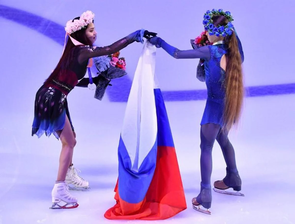 First place winner Russia's Alexandra Trusova (R) and second place winner Evgenia Medvedeva (L) hold the national flag after a rewarding ceremony at the Rostelecom Cup 2019 ISU Grand Prix of Figure Skating in Moscow on November 17, 2019. Yuri KADOBNOV / AFP