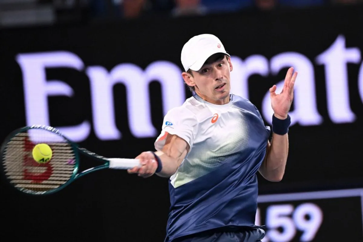 Australia's Alex De Minaur hits a return against USA's Alex Michelsen during their men's singles match on day nine of the Australian Open tennis tournament in Melbourne on January 20, 2025.  WILLIAM WEST / AFP