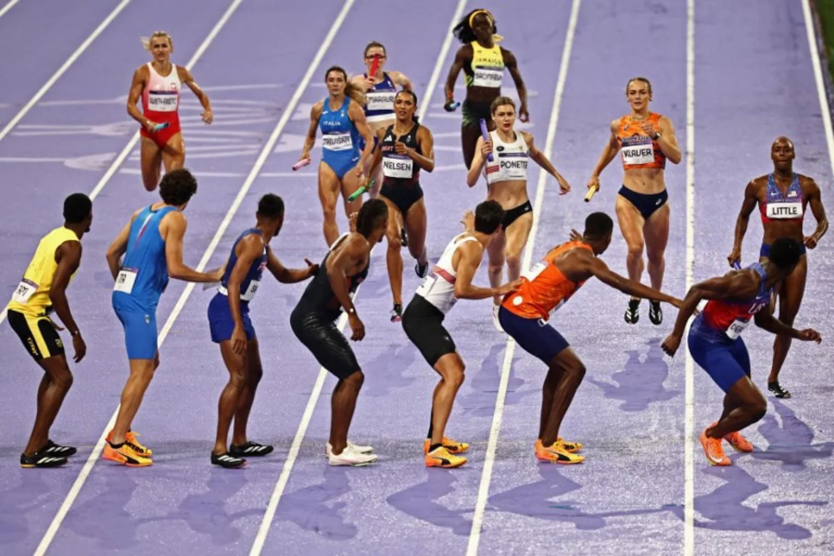 Athletes compete in the mixed 4x400m relay final of the athletics event at the Paris 2024 Olympic Games at Stade de France in Saint-Denis, north of Paris, on August 3, 2024.  Anne-Christine POUJOULAT / AFP