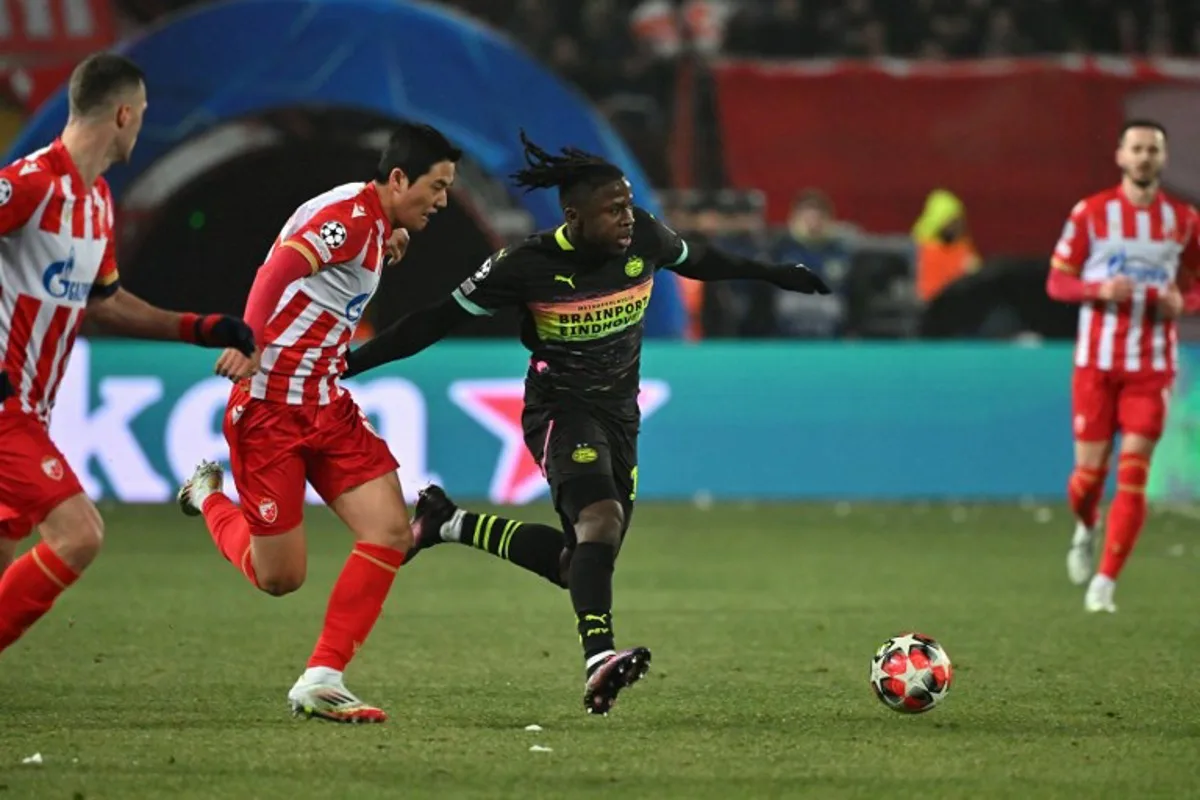 PSV Eindhoven's Belgian forward #11 Johan Bakayoko (C) and Crvena Zvezda Beograd's South Korean defender #66 Seol Young-woo (2L) fight for the ball during the UEFA Champions League, league phase day 7, football match between FK Crvena Zvezda (SRB) and PSV Eindhoven (NED) at the Rajko Mitic stadium in Belgrade, on January 21, 2025.  Andrej ISAKOVIC / AFP