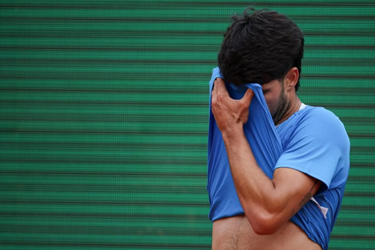 Spain's Carlos Alcaraz reacts as he plays against Italy's Jannik Sinner during the Monte Carlo ATP Masters Series Tournament final tennis match on Court Rainier III at the Monte-Carlo Country Club in Roquebrune-Cap-Martin, south-eastern France on April 12, 2026. Valery HACHE / AFP