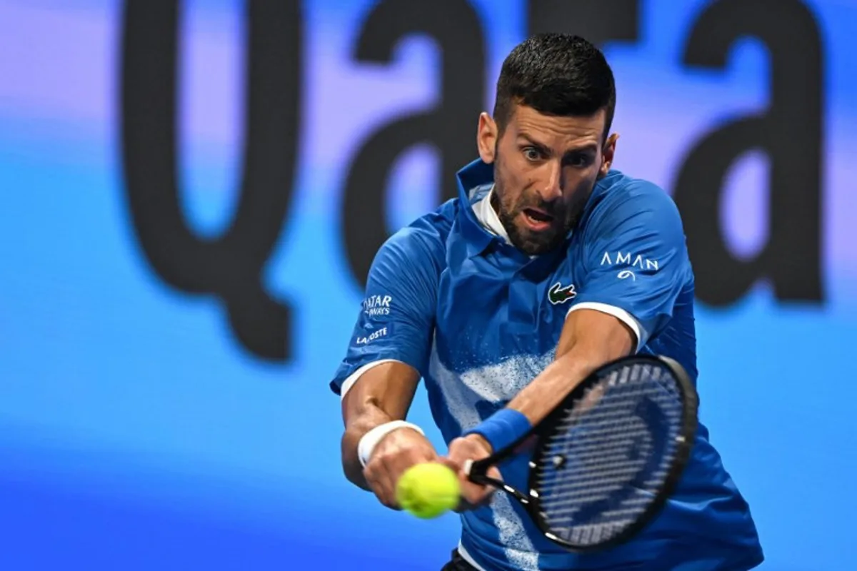 Serbia's Novak Djokovic hits a return to Italy's Matteo Berettini during their men's singles match at the ATP Qatar Open tennis tournament in Doha on February 18, 2025.  Mahmud HAMS / AFP