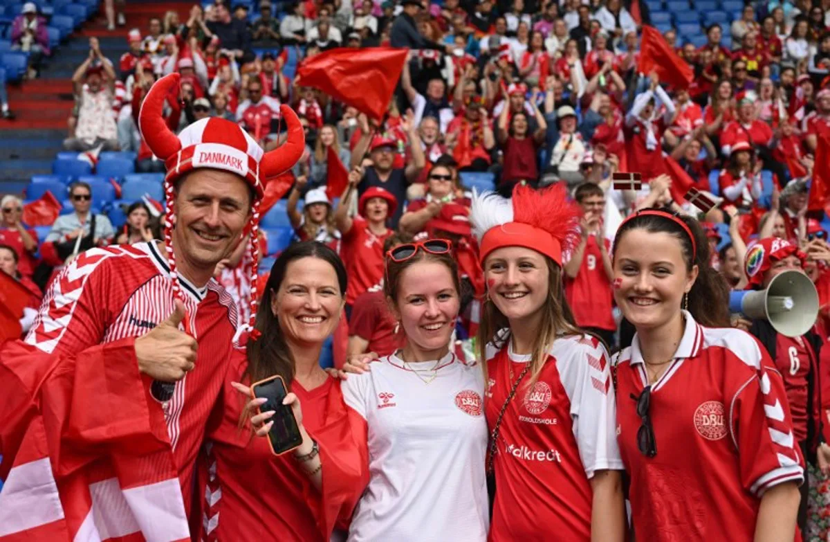 Denmark supporters pose prior to the UEFA Women's Euro 2025 Group C football match between Germany and Denmark at the at the St Jakob-Park Stadium, in Basel on July 8, 2025. Miguel MEDINA / AFP