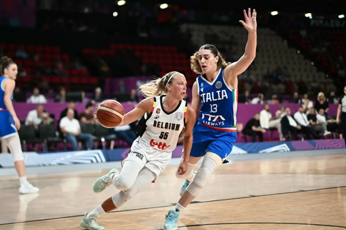Belgium's point guard Julie Allemand (L) is defended by Italy's center Lorela Cubaj during the FIBA Women's EuroBasket 2025 semi-final match between Italy and Belgium at the Peace and Friendship Stadium in Athens on June 27, 2025. Angelos Tzortzinis / AFP