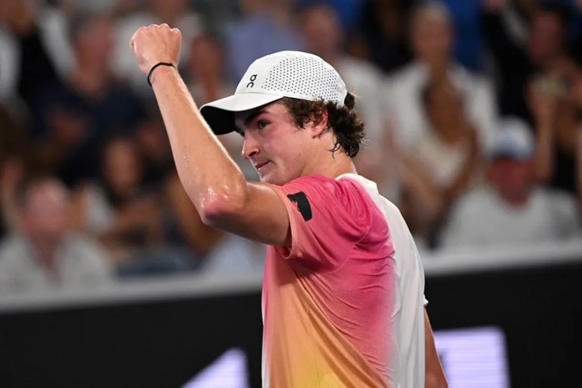 Brazil's Joao Fonseca reacts to winning the first set against Russia's Andrey Rublev during their men's singles match on day three of the Australian Open tennis tournament in Melbourne on January 14, 2025.  WILLIAM WEST / AFP