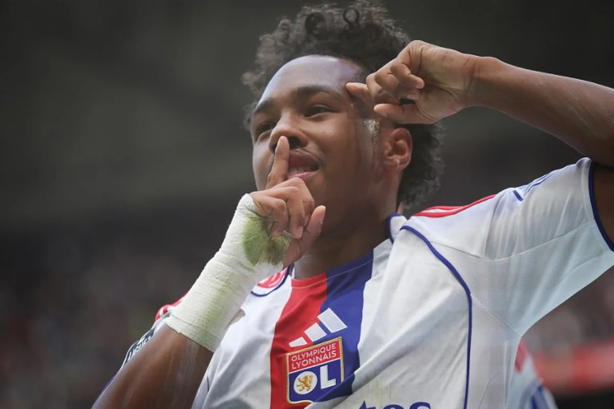 Lyon's Belgian forward #11 Malick Fofana celebrates after scoring during the French L1 football match between Olympique Lyonnais and Toulouse FC at the Parc Olympique Lyonnais in Decines-Charpieu, outside Lyon on October 5, 2025. Alex MARTIN / AFP