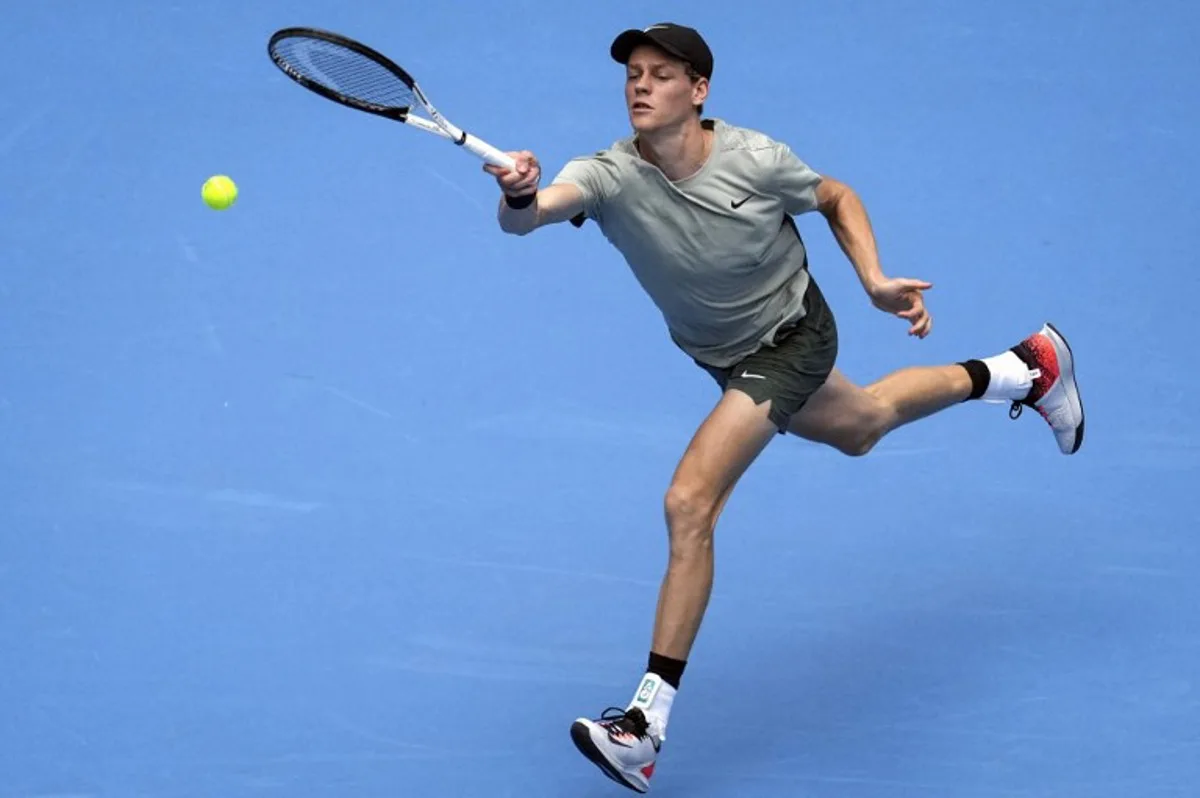 Italy's Jannik Sinner hits a return against Chile's Nicolas Jarry during their men's single round of 32 match at the China Open tournament in Beijing on September 26, 2024.  STRINGER / AFP