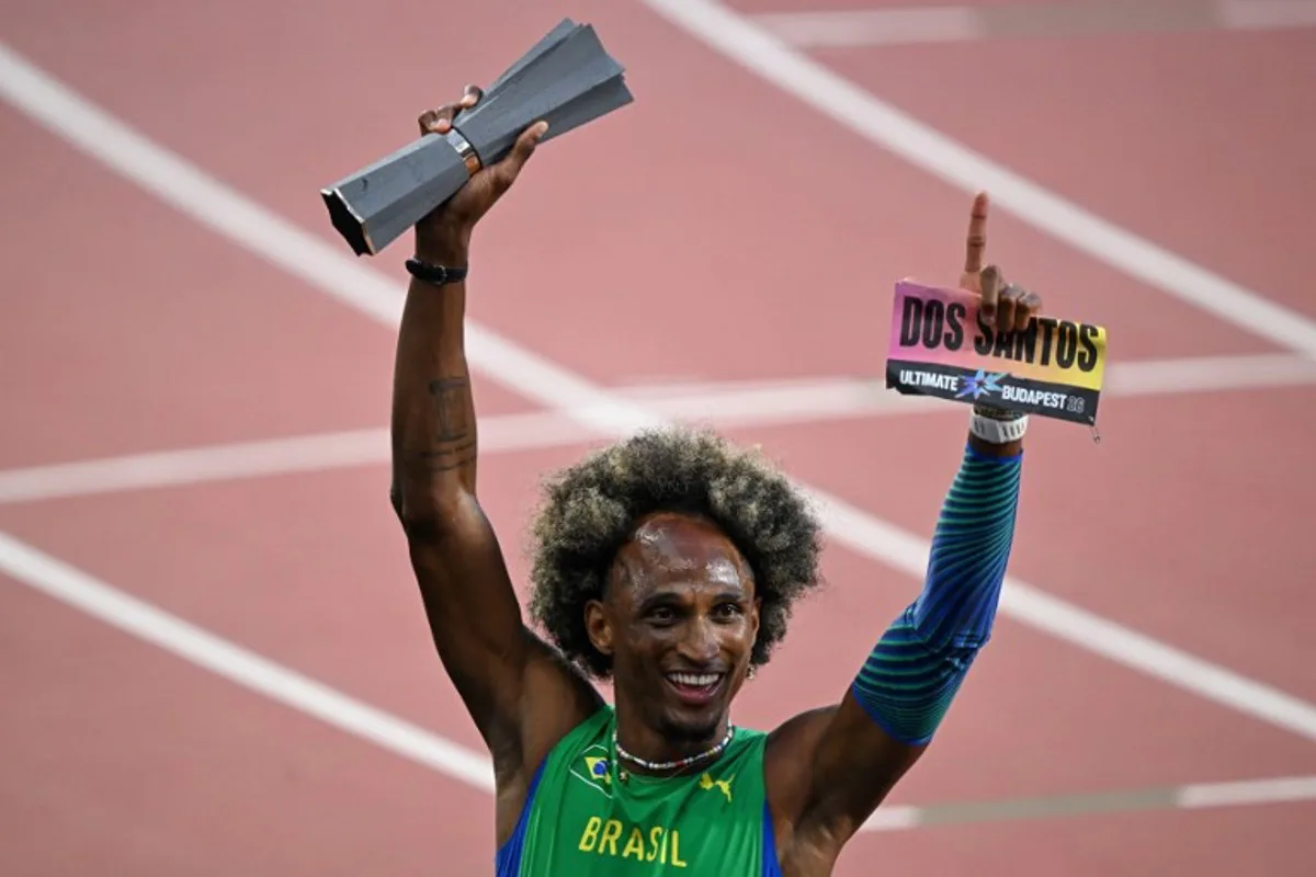 Brazil's Alison Dos Santos celebrates with his trophy after winning men's 400m hurdles final during the World Athletics Ultimate Championship at the Gyula Zsivotzky National Athletics Centre, in Budapest on September 13, 2026.  Attila KISBENEDEK / AFP
