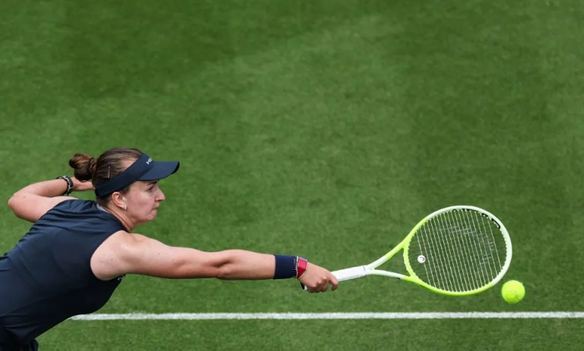 Czech Republic's Barbora Krejcikova plays a backhand return to Britain's Jodie Burrage during their women's singles round of 16 tennis match on day three at the Rothesay Eastbourne International tennis tournament in Eastbourne, southern England, on June 25, 2025. Adrian Dennis / AFP