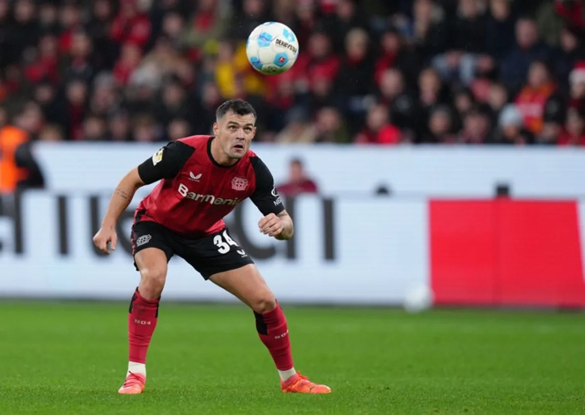Bayer Leverkusen's Swiss midfielder #34 Granit Xhaka eyes the ball during the German first division Bundesliga football match between Bayer Leverkusen and SC Freiburg in Leverkusen on December 21, 2024. Pau BARRENA / AFP