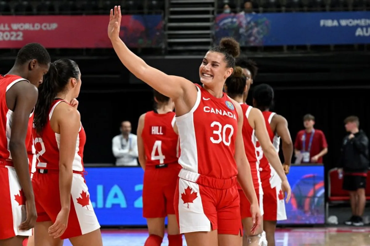 Canada's Taya Hanson (C) celebrates with team mates the victory during the Women's Basketball World Cup group B game between Canada and Mali in Sydney on September 27, 2022.   WILLIAM WEST / AFP