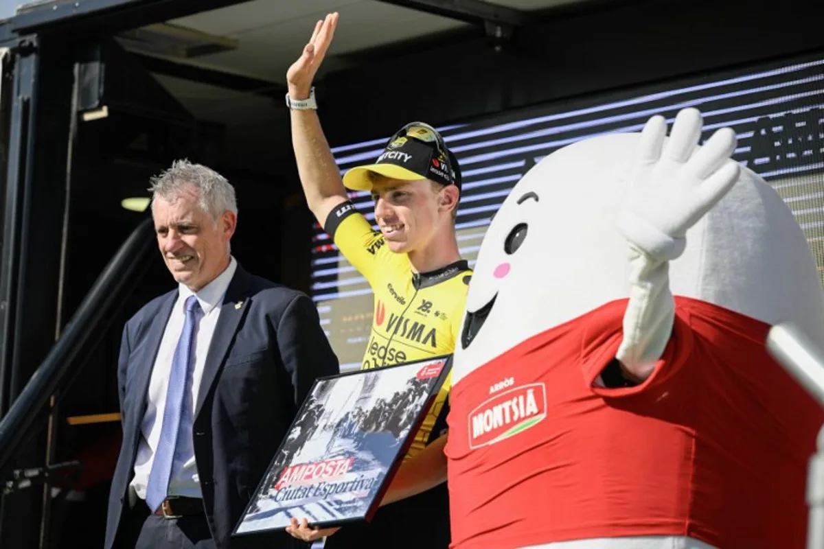 Team Visma-Lease a bike's Matthew Brennan celebrates on the podium after winning the 5th stage of the 2025 Volta a Catalunya cycling tour of Catalonia, a 172 km race between Pauls and Amposta, on March 28, 2025. Josep LAGO / AFP