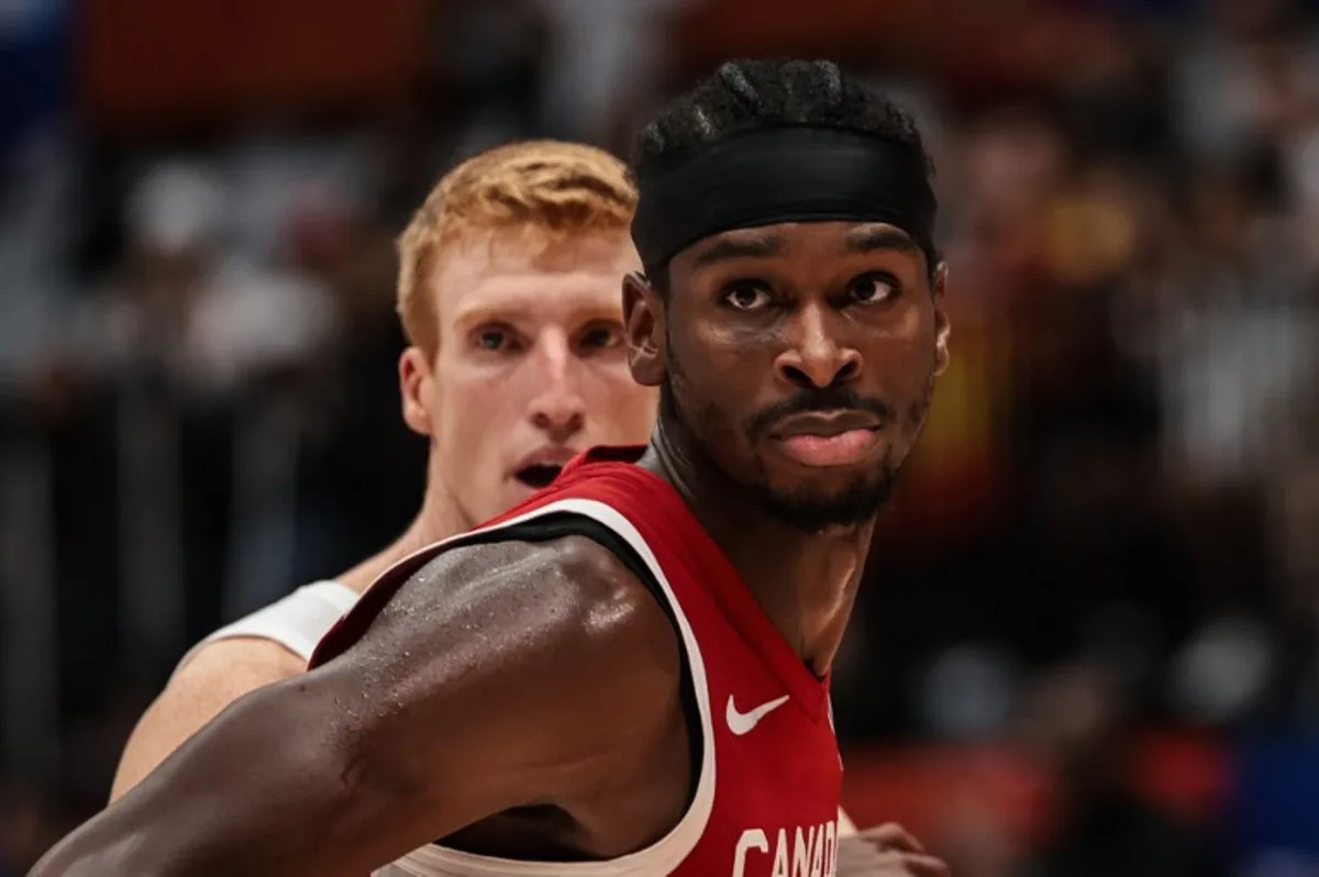 Canada's Shai Gilgeous-Alexander (R) reacts as Spain's Alberto Diaz tries to block him during the FIBA Basketball World Cup group L match between Spain and Canada at Indonesia Arena in Jakarta on September 3, 2023.   Yasuyoshi CHIBA / AFP