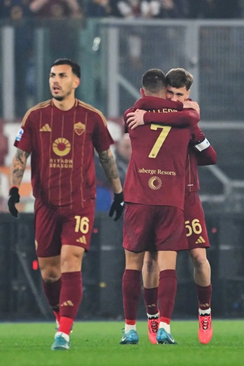 Roma's Italian midfielder #07 Lorenzo Pellegrini celebrates with Roma Belgian's forward #56 Alexis Saelemaekers (R) after scoring a goal during the Italian Serie A football match between Roma and Lazio, at the Olympic stadium in Rome on January 5, 2025.  Andreas SOLARO / AFP