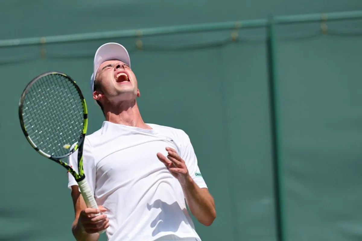 Britain's Oliver Tarvet reacts as he plays against Switzerland's Leandro Riedi during their men's singles first round tennis match on the first day of the 2025 Wimbledon Championships at The All England Lawn Tennis and Croquet Club in Wimbledon, southwest London, on June 30, 2025. Adrian Dennis / AFP