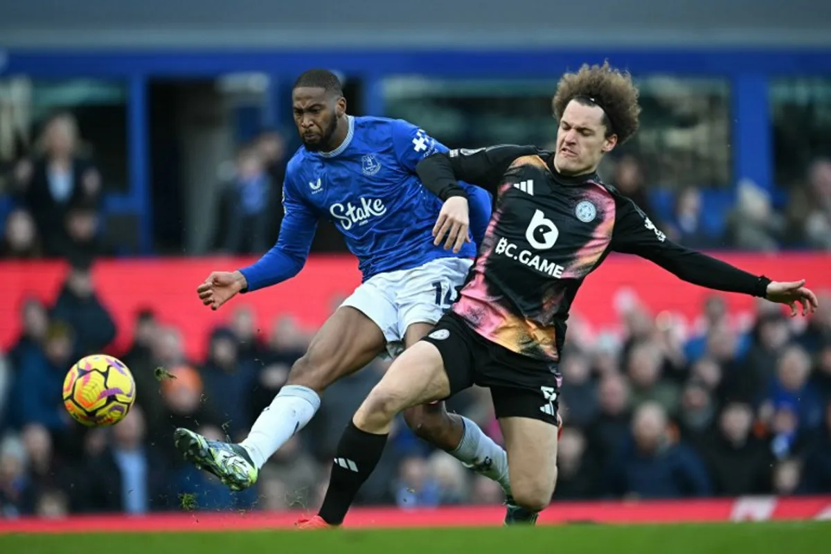 Everton's Portuguese striker #14 Beto (L) shoots to score their second goal under pressure from Leicester City's Belgian defender #03 Wout Faes (R) during the English Premier League football match between Everton and Leicester City at Goodison Park in Liverpool, north west England on February 1, 2025.  Paul ELLIS / AFP