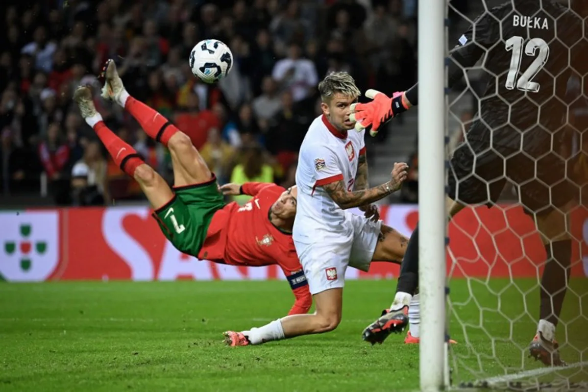 Portugal's forward Cristiano Ronaldo (L) scores their fifth goal during the UEFA Nations League, League A, Group 1 football match between Portugal and Poland at the Dragao stadium in Porto, on November 15, 2024.  Miguel RIOPA / AFP