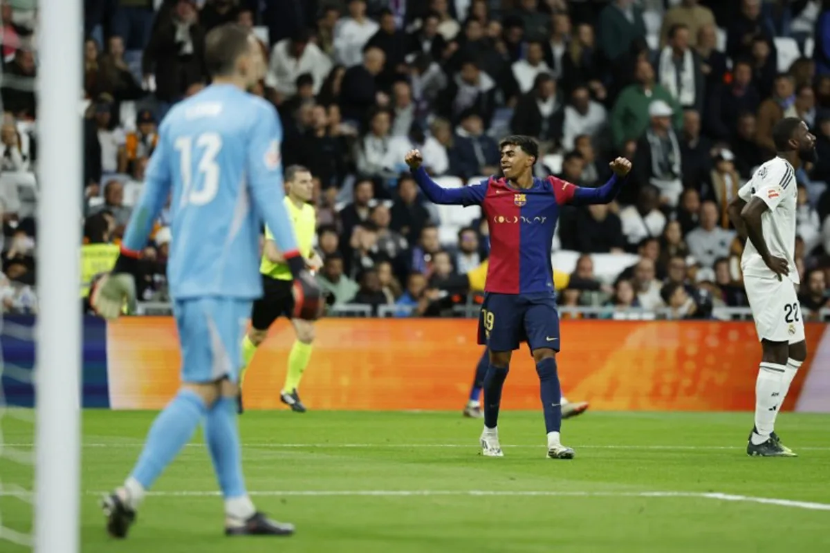 Barcelona's Spanish forward #19 Lamine Yamal celebrates at the end of the Spanish league football match between Real Madrid CF and FC Barcelona at the Santiago Bernabeu stadium in Madrid on October 26, 2024.  OSCAR DEL POZO / AFP