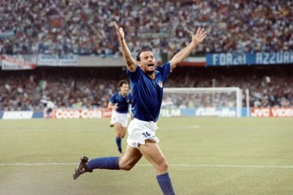 Italian forward Salvatore Schillaci exults after scoring his team's first goal during the World Cup semifinal soccer match between Italy and Argentina 03 July 1990 in Naples.  Argentina and Italy played to a 1-1 tie but Argentina advanced to the finals with a 4-3 victory on penalty kicks dashing the hopes of Italian fans of a World Cup victory by their team on home soil.   DANIEL GARCIA / AFP