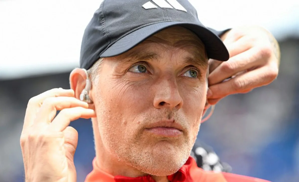 Bayern Munich's German head coach Thomas Tuchel adjusts the headphones for an interview, prior to during the German first division Bundesliga football match between TSG 1899 Hoffenheim and FC Bayern Munich in Sinsheim, southwestern Germany on May 18, 2024.  Thomas KIENZLE / AFP