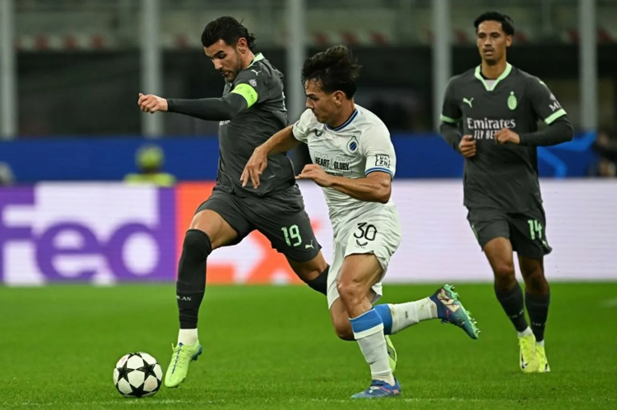 AC Milan's French defender #19 Theo Hernandez fights for the ball with Club Brugge's Swiss midfielder #30 Ardon Jashari during the Champions League football match between AC Milan and Club Brugge at the San Siro stadium in Milan on October 22, 2024.  Gabriel BOUYS / AFP