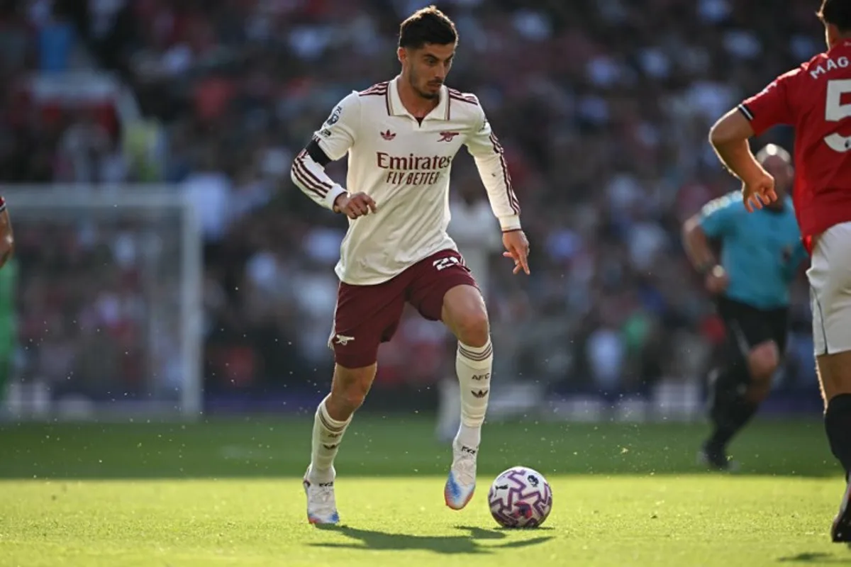 Arsenal's German midfielder #29 Kai Havertz runs with the ball during the English Premier League football match between Manchester United and Arsenal at Old Trafford in Manchester, north west England, on August 17, 2025. Paul ELLIS / AFP
