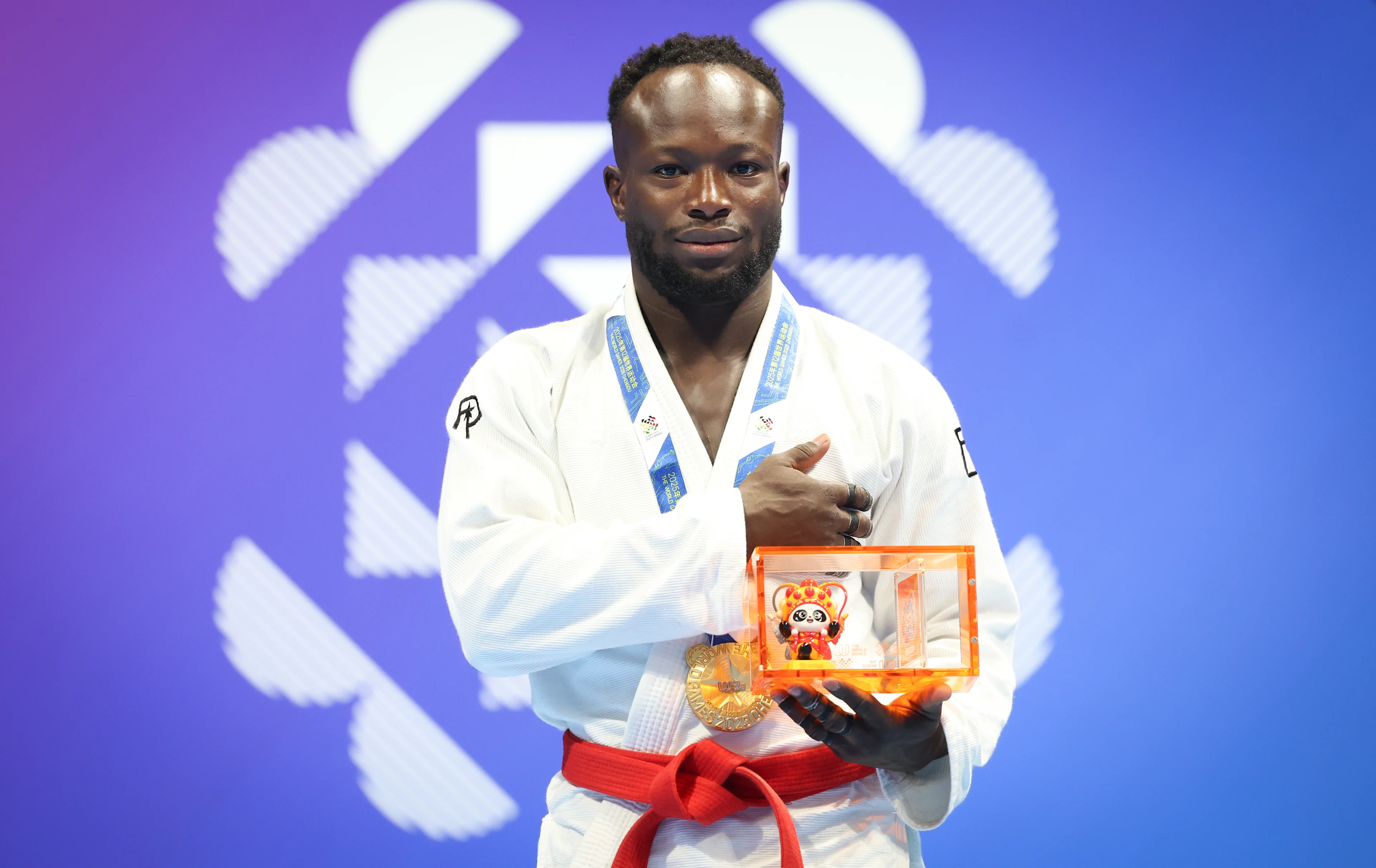 Belgian Florian Bayili celebrates on the podium as he won the gold medal after a fight with United Arab Emirates' Alsuwaidi, the final game in the Ju-Jitsu Men's -69kg Ne-Waza competition during the World Games 2025, in Chenghdu, China, on Monday 11 August 2025. This year, the World Games take place from 07 to 17 augustus. BELGA PHOTO VIRGINIE LEFOUR