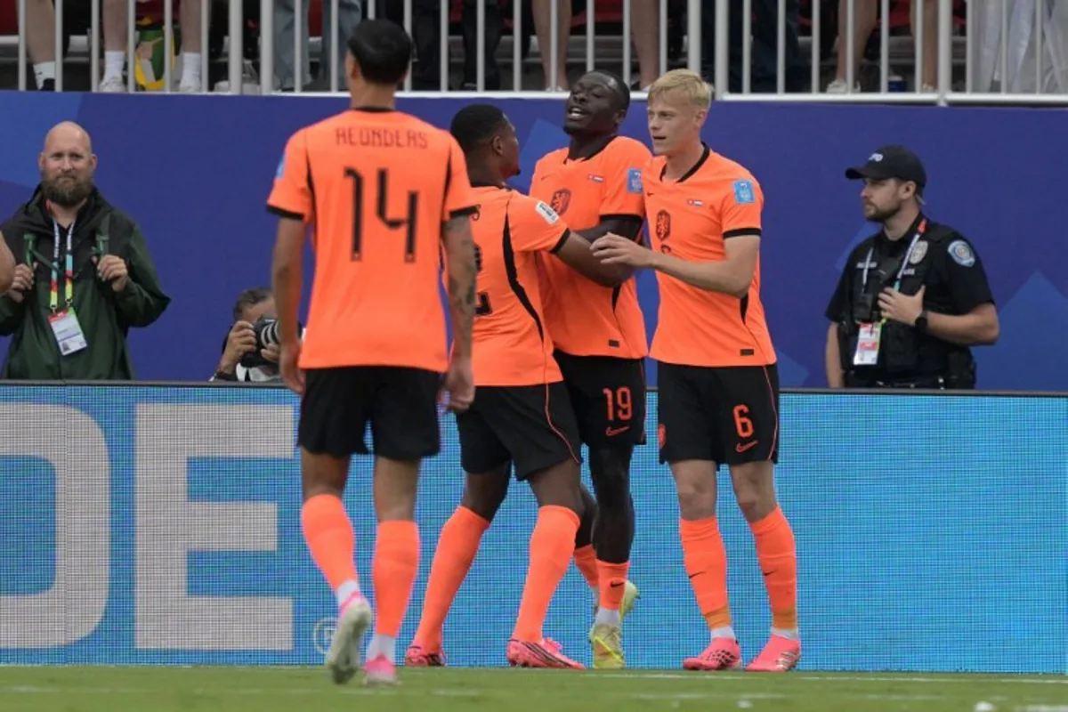 Netherlands' forward #19 Brian Brobbey (2nd R) celebrates scoring his team's second goal with defender #06 Jan Paul Van Hecke (R) during the 2026 World Cup Group F football match between Tunisia and the Netherlands at the Kansas City Stadium in Kansas City on June 25, 2026.   Juan MABROMATA / AFP